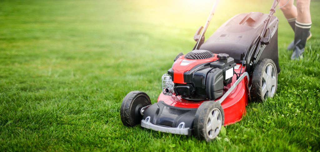 A red, push-style lawn mower.