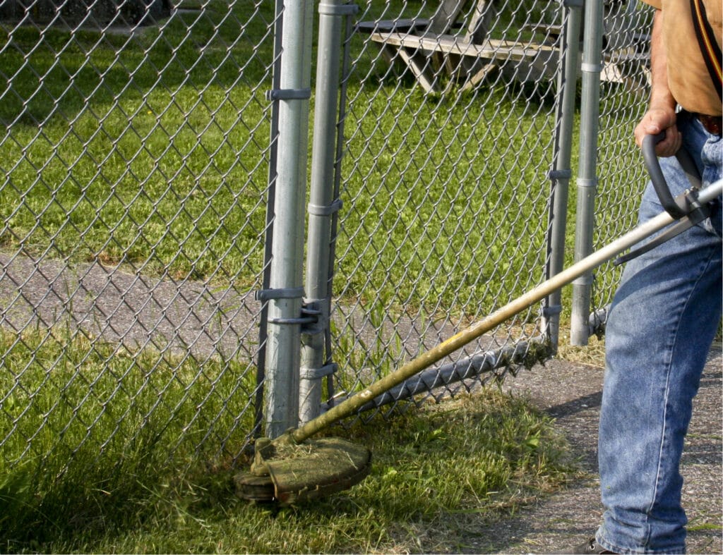 weed whacker may be good for getting rid of grass where lawn mowers cannot reach